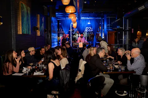 Musicians on stage entertaining a lively dinner crowd